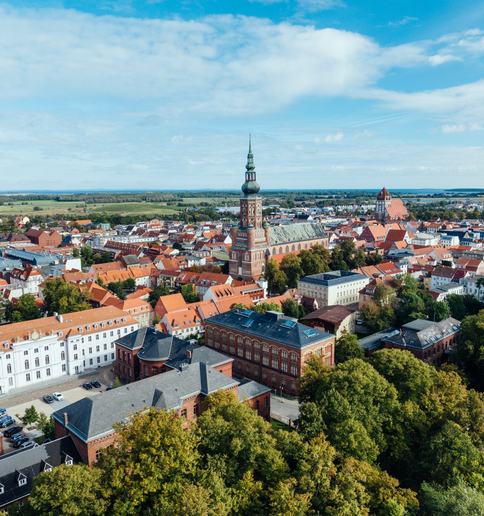 The silhouette of Greifswald from the air and view of the church towers.
