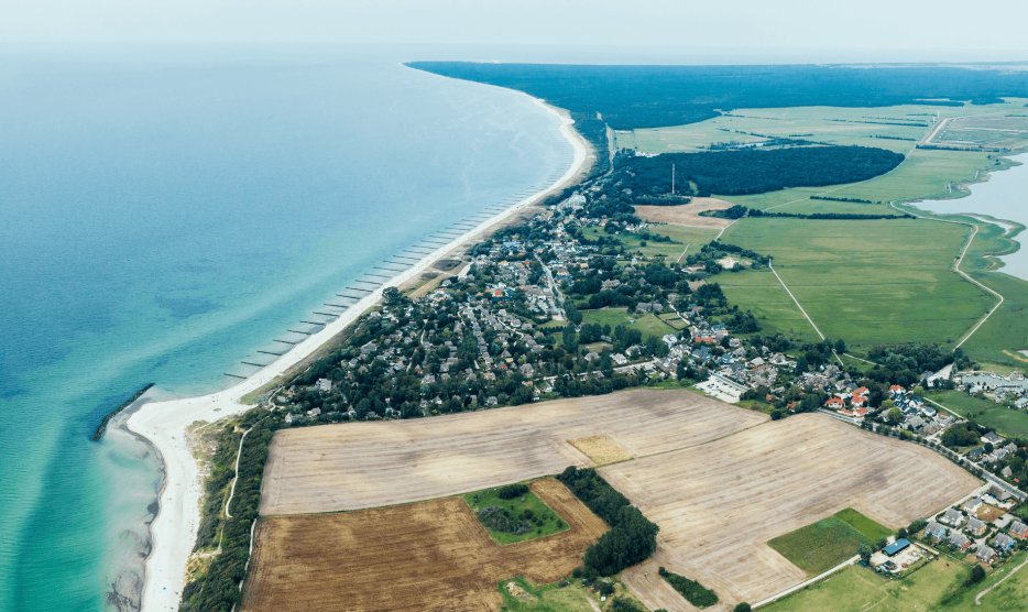 The Fischland-Darß peninsula from the air and the Baltic Sea beach near Ahrenshoop with a view of the western beach on the horizon.