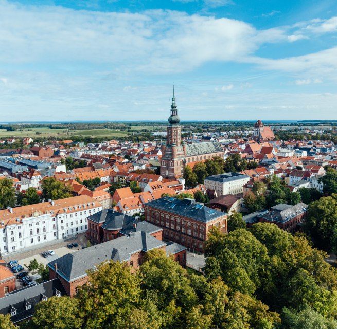 The silhouette of Greifswald from the air and view of the church towers.