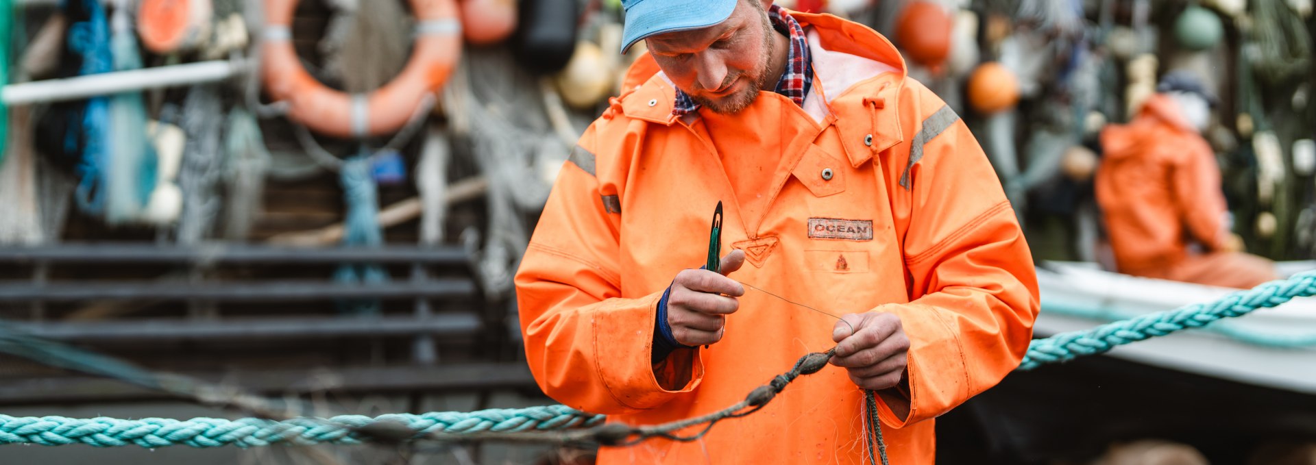 A fisherman in Mönchgut mends his nets.